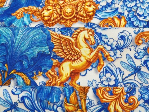 jedwab w niebieskie irysy i ornamenty raz złote słońca i pegazy na bialym tle