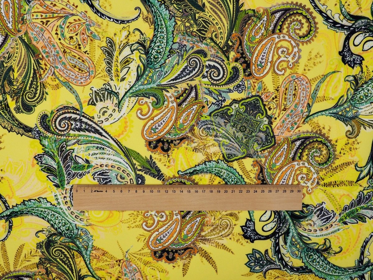 Lycra dzianina - Kolorowe paisley na kanarkowym tle Lycra dzianina - Kolorowe paisley na kanarkowym tle