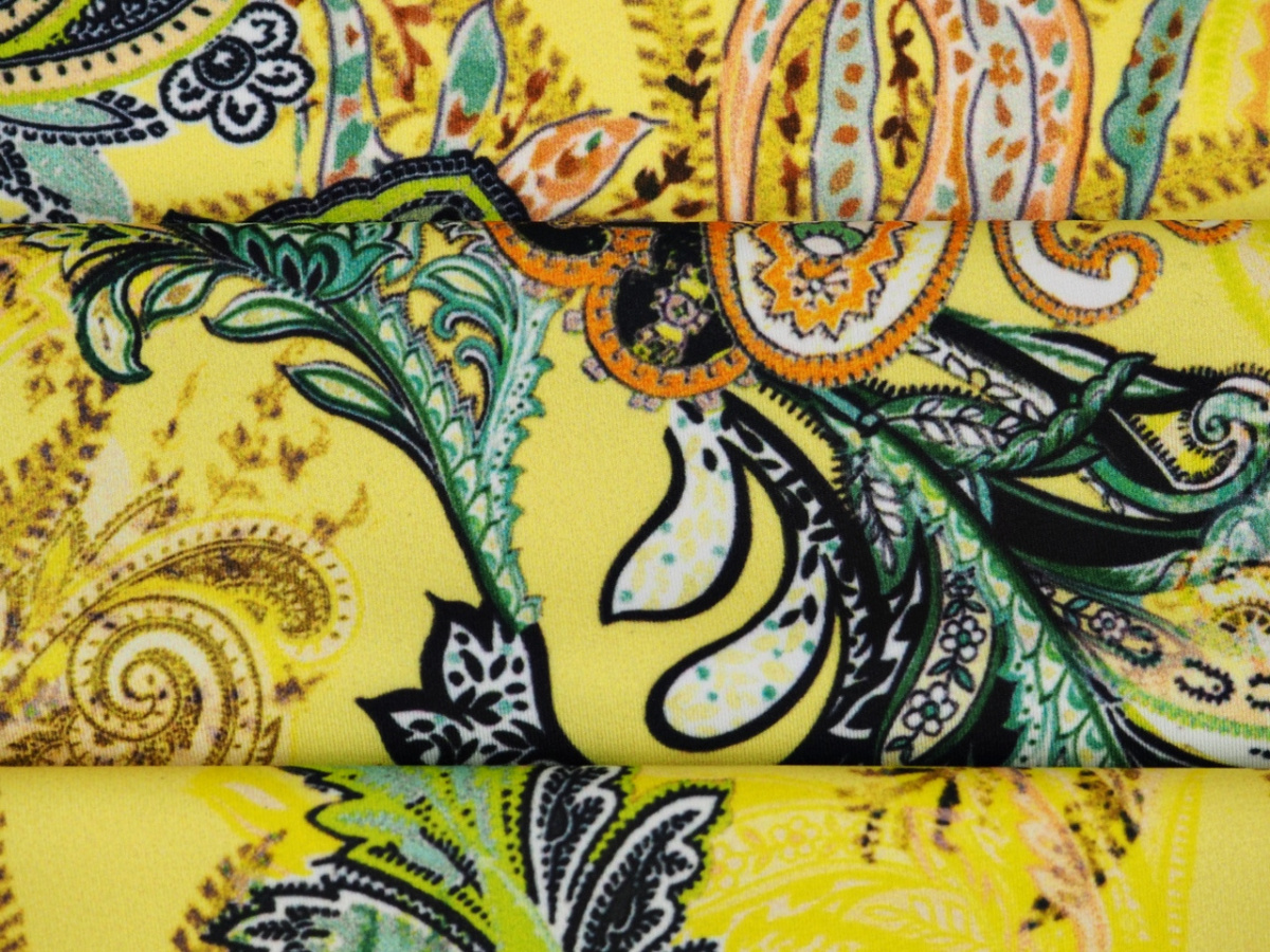 Lycra dzianina - Kolorowe paisley na kanarkowym tle Lycra dzianina - Kolorowe paisley na kanarkowym tle
