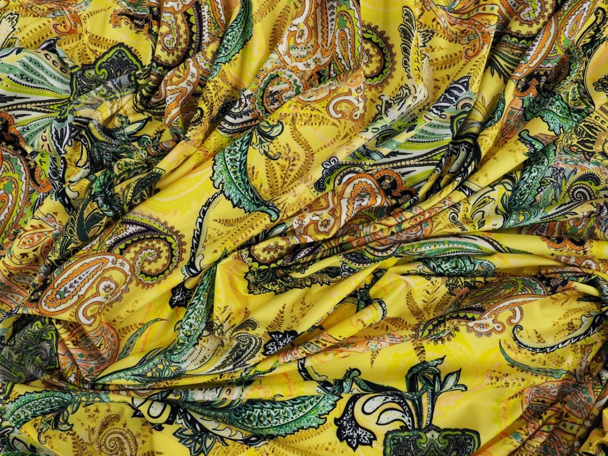 Lycra dzianina - Kolorowe paisley na kanarkowym tle Lycra dzianina - Kolorowe paisley na kanarkowym tle