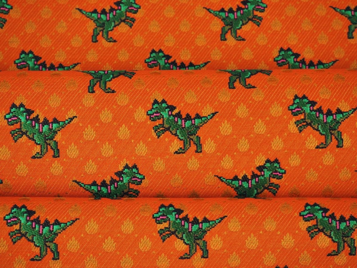 Żakard jedwabny - Dinozaury na pomarańczowym tle Żakard jedwabny - Dinozaury na pomarańczowym tle